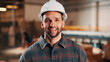 © peopleimages.com - Carpentry, portrait and happy man in factory with helmet, handyman or ambition in manufacturing industry. Smile, hardhat or carpenter with about us, production career or confidence in woodworking.