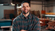 © peopleimages.com - Carpentry, portrait and man in warehouse with arms crossed, handyman or pride in manufacturing industry. Smile, ambition or artisan with about us, production career or confidence in woodworking.