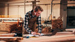 © peopleimages.com - Carpentry, serious and man on laptop in workshop for planning, schedule or manufacturing quote. Warehouse, male person or carpenter with technology for woodwork or furniture production with paperwork