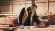 © peopleimages.com - Carpentry, mature and man on laptop in workshop for planning, schedule or manufacturing quote. Warehouse, male person or carpenter with technology for woodwork or furniture production with paperwork