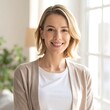 © hut - Smiling middle-aged woman in beige cardigan.