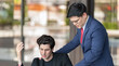 © BESTIMAGE - Stressed young businessman holding head in hand receiving criticism by manager after discussing document error on laptop for work mistake at outdoor office business pressure leadership feedback.