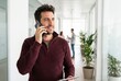 © 형근 최 - Generative AI, Businessman talking on smartphone while holding tablet in office corridor