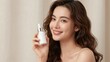 © Worldwide - Smiling woman with beautiful wavy hair holding a beauty serum bottle, showcasing radiant skin against a plain background.