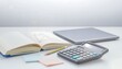 © Linda - Modern workspace with study materials and calculator.
