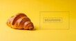 © Sheikh - Freshly baked croissant on vibrant yellow background minimalist food photography