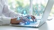 © Sadia - Person typing on laptop with virtual network