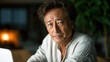© visoot - Mature Japanese man close up, thoughtful expression, casual white shirt, indoor setting, soft lighting, natural background