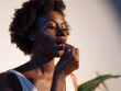 © Milles Team/Stocksy - Woman putting vitamins into her mouth