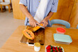 © Adrian Rodd/Stocksy - Anonymous, healthy man chopping appaya