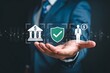 © MSTFARJANAHOSSAIN - Businessman hand holding financial banking and insurance security icons