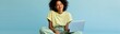 © Andrii Zastrozhnov - Young woman sitting with laptop on pastel blue background for remote work and study background and design