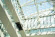 © timoha.ig - Interior view of a modern architectural glass atrium with abundant natural light. Corporate building design and contemporary workplace environment