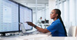 © Andrey Popov - Young African Woman Healthcare Manager Updates Patient Records Using Laptop
