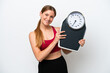 © luismolinero - Young pretty blonde woman isolated on white background with weighing machine