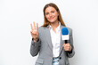 © luismolinero - Young caucasian tv presenter woman isolated on white background happy and counting three with fingers