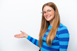 © luismolinero - Young caucasian woman isolated on white background extending hands to the side for inviting to come