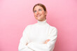 © luismolinero - Young caucasian woman isolated on pink background looking up while smiling