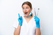 © luismolinero - Dentist caucasian woman holding tools isolated on white background thinking an idea pointing the finger up