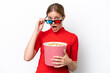 © luismolinero - Young caucasian woman isolated on white background surprised with 3d glasses and holding a big bucket of popcorns