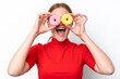 © luismolinero - Young caucasian woman isolated on white background holding donuts in an eye