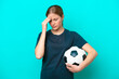 © luismolinero - Young football player woman isolated on blue background with headache