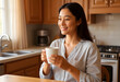© Pixel-Shot - Young woman enjoying a hot drink in kitchen