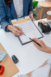 © PHOTO4U - Car purchase transaction with payment, contract signing, key handover, and customer agreement in a modern dealership office, representing automotive sales, business finance, and professional service.