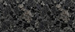 © UmmeFarhatunnesa - Black granite texture displays a bold slate stone surface filled with sharp dark crystals and glinting mineral specks across the rugged rock