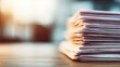 © Ismail - Close-up view of a thick stack of health policy documents on a wooden desk with soft background lighting