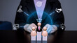 © harit - Business leader wooden doll on a podium with digital corporate goal and success icons overlay, representing leadership, team management, and human resources strategy.
