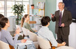 © JackF - Confident professor giving a lecture and using a clicker near monitor in classroom