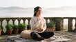 © tangmo.pa - Serene woman practicing morning breathwork and meditation on a foggy terrace.