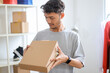 © Gatot - Young Asian Male Entrepreneur Packing Cardboard Box for Shipping