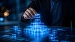 © Ahmed - Digital business architecture and tech foundation concept with a hand building a glowing blue holographic cube pyramid