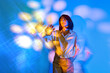 © VISTA by Westend61 - Woman touches a glowing virtual interface in a surreal future