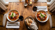 © Creative - Dinner table setting with pasta bowls and fresh bread basket parmesan romantic candlelight homemade restaurant together appetizing delicious vegetarian