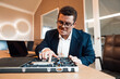© BusinessClass by W61 - Male engineer with freckles repairs hardware at the office