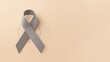 © VolumeThings - Beige backdrop with a grey awareness ribbon. Brain cancer theme.