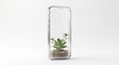 © M Ilham Juliansyah - Sleek modern smartphone clear glass small green plant growing inside