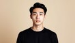 © Kuroko - Portrait of a stylish young asian man with striking features against neutral backdrop