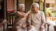 © Vantiya dipakbhai  - Heartwarming moment of an elderly senior Indian sister applying tilak on her brother's forehead during Rakshabandhan celebration, sitting on a wooden bench in a traditional courtyard.