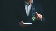 © Ruby Laden - A businessman in a suit using a smartphone to select a green checkmark on a digital checklist, representing task completion and success