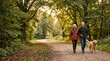 © Bohdan - Older couple walking dog in forest park