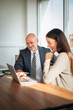 © gzorgz - Business colleagues reviewing information on laptop during office meeting