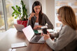 © gzorgz - Businesswoman sharing ideas during meeting in modern office
