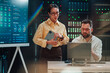 © Zamrznuti tonovi - It engineers collaborating on network infrastructure planning in a modern data center server room with data screens