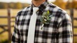 © Ksenia - Groom flannel shirt tie closeup with checkered plaid and boutonniere in golden light