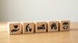 © alex - Insurance concepts represented by wooden blocks with icons for safety, protection, and well-being