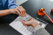 © PHOTO4U - Concept of bribery, corruption, and unethical business practices with cash offered during a legal contract meeting, highlighting financial crime, integrity, compliance, and corporate ethics.